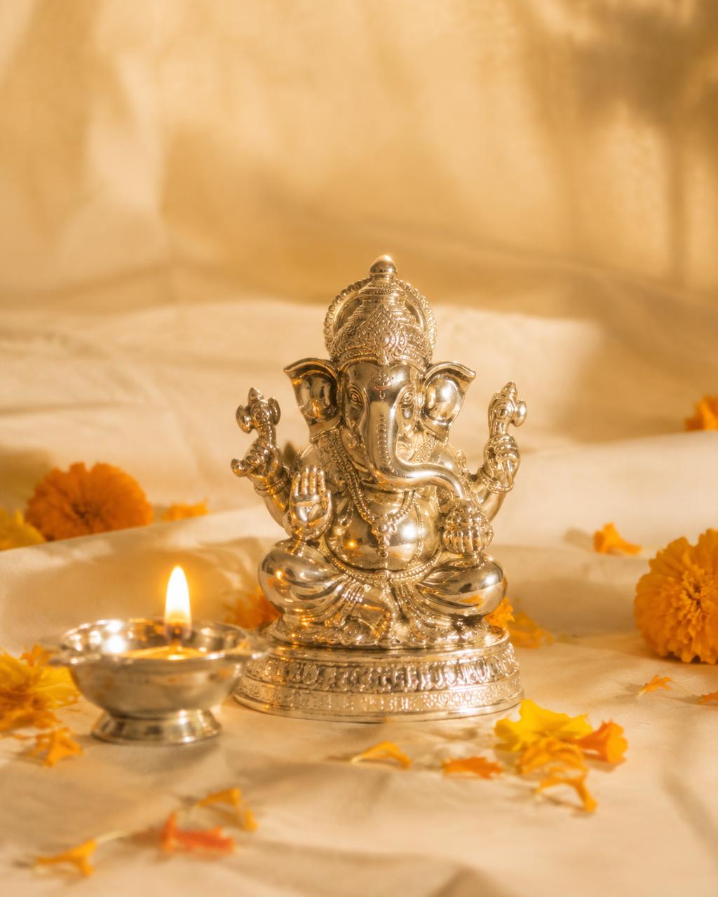 Silver plated Ganesha idol with diya